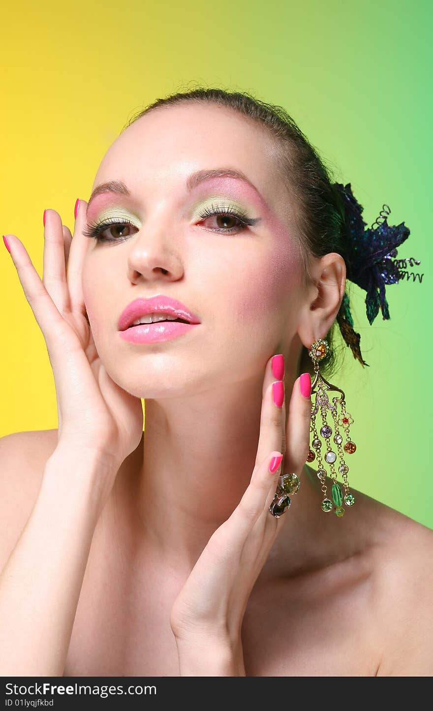 Beautiful girl with make up on yellow-green background