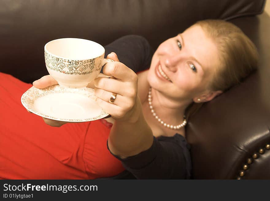 Beautiful young woman enjoying a cup of tea. Beautiful young woman enjoying a cup of tea