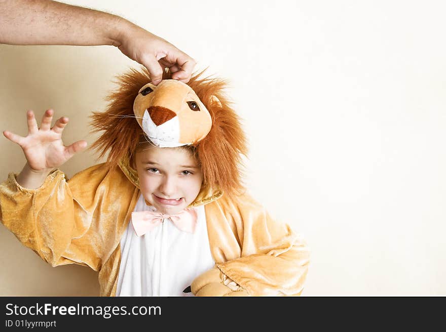 Playful young boy wearing a lion costume. Playful young boy wearing a lion costume