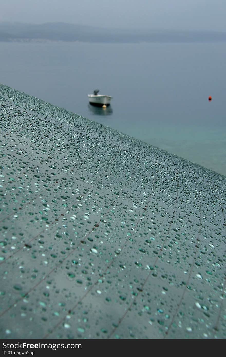 Rain on car window and boat