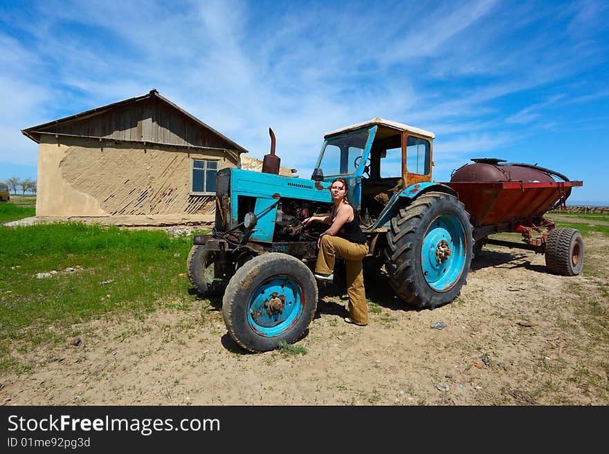 The girl repairs an old tractor