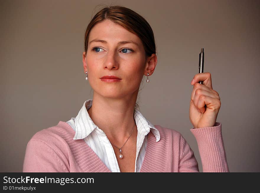 Attractive thoughtful women holding a pen. Attractive thoughtful women holding a pen