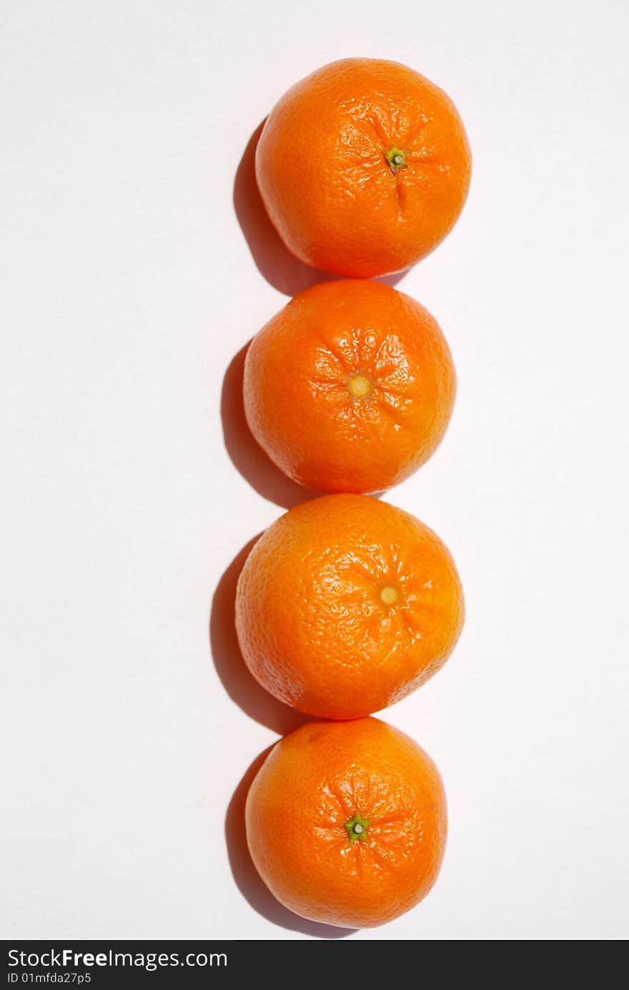 Delicious and juicy orange tangerines grouped together vertically and isolated on white. Delicious and juicy orange tangerines grouped together vertically and isolated on white.