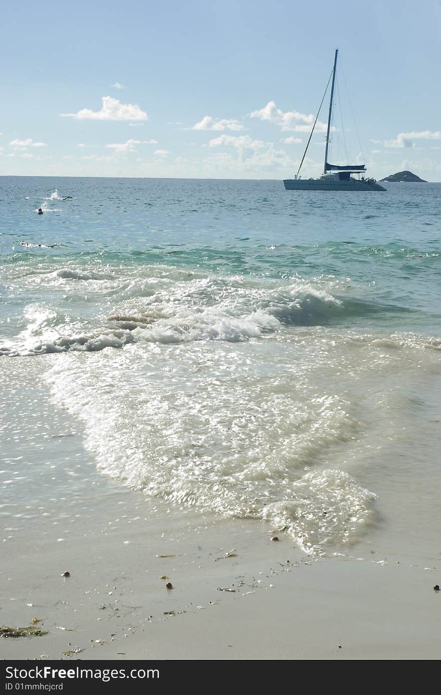 A sailboat in Indian ocean on Anse Lazio beach.