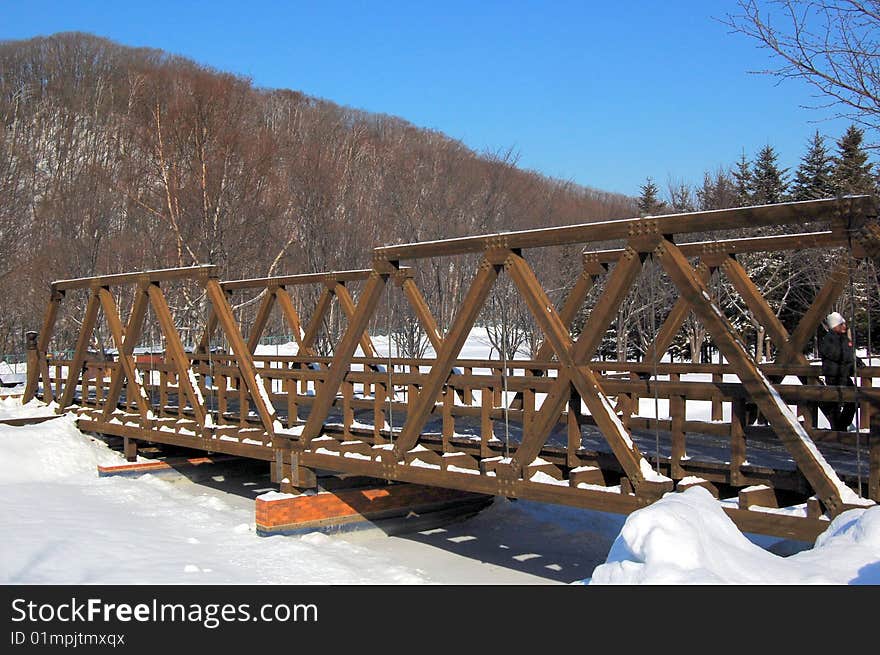 Wooden Bridge And Frozen River