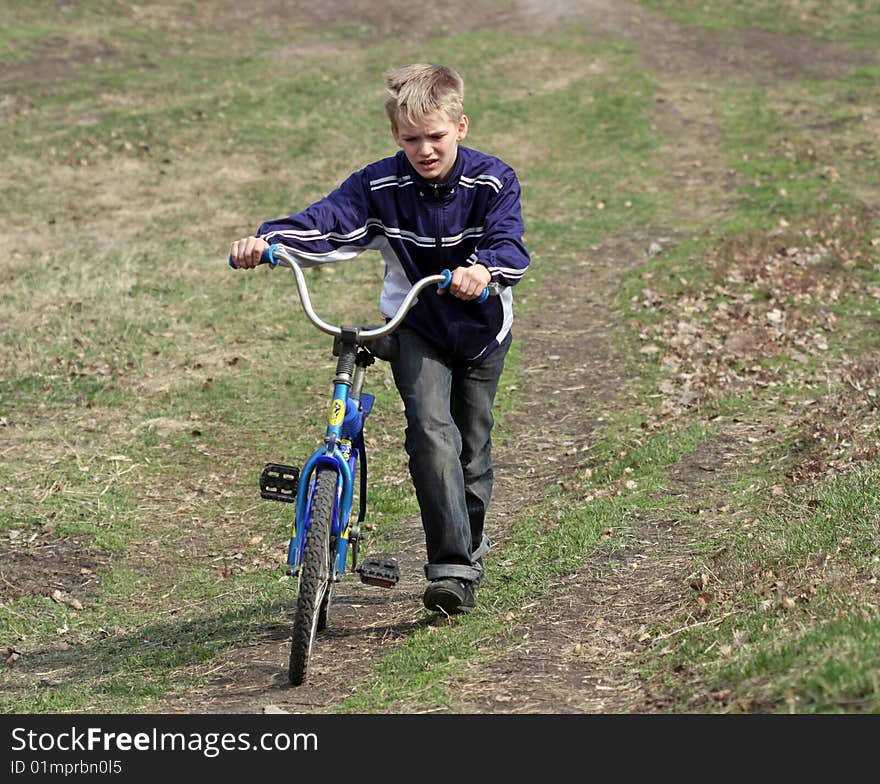 Boy uphill climbs by bike