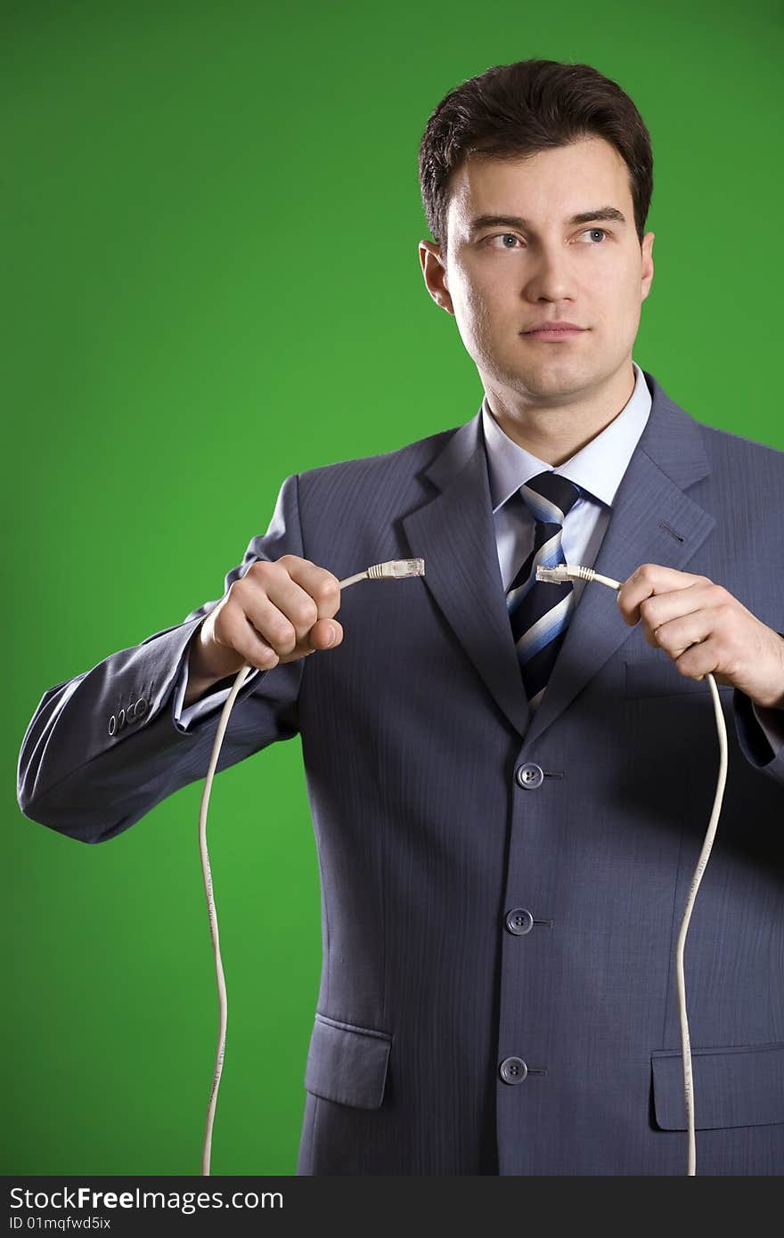 Man with wires in his hands on green background