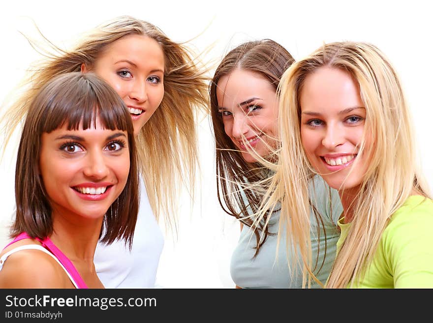 Four beautiful happy young women with a smile in bright multi-coloured clothes. Four beautiful happy young women with a smile in bright multi-coloured clothes