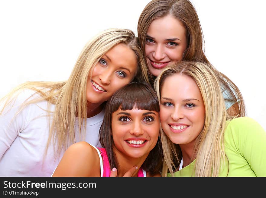 Four beautiful happy young women with a smile in bright multi-coloured clothes. Four beautiful happy young women with a smile in bright multi-coloured clothes