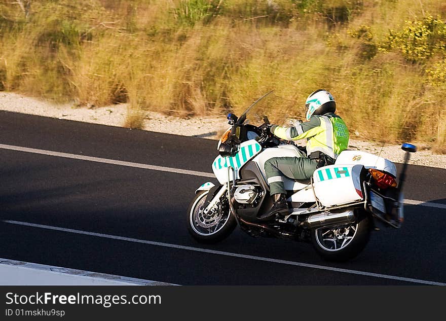 Police Motorbike rider races up hill to serve and protect. Spanish bike rider in 2009 Moto GP. Police Motorbike rider races up hill to serve and protect. Spanish bike rider in 2009 Moto GP