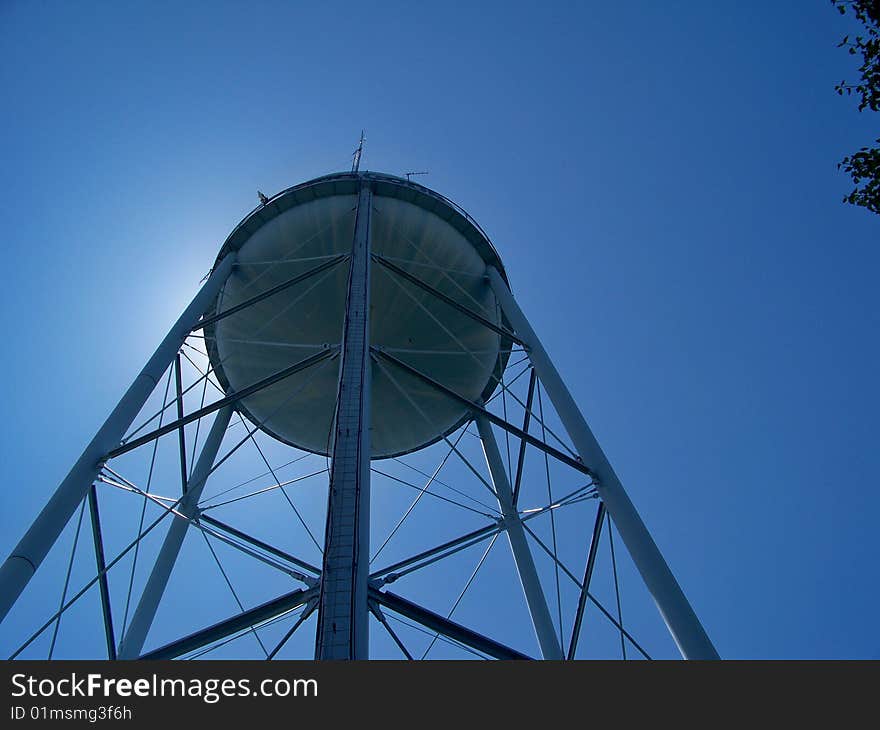 A blue water tower reaching for the sky. A blue water tower reaching for the sky