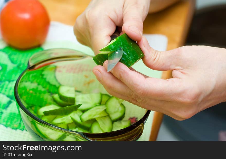 Woman cutting vegetables close up. Woman cutting vegetables close up