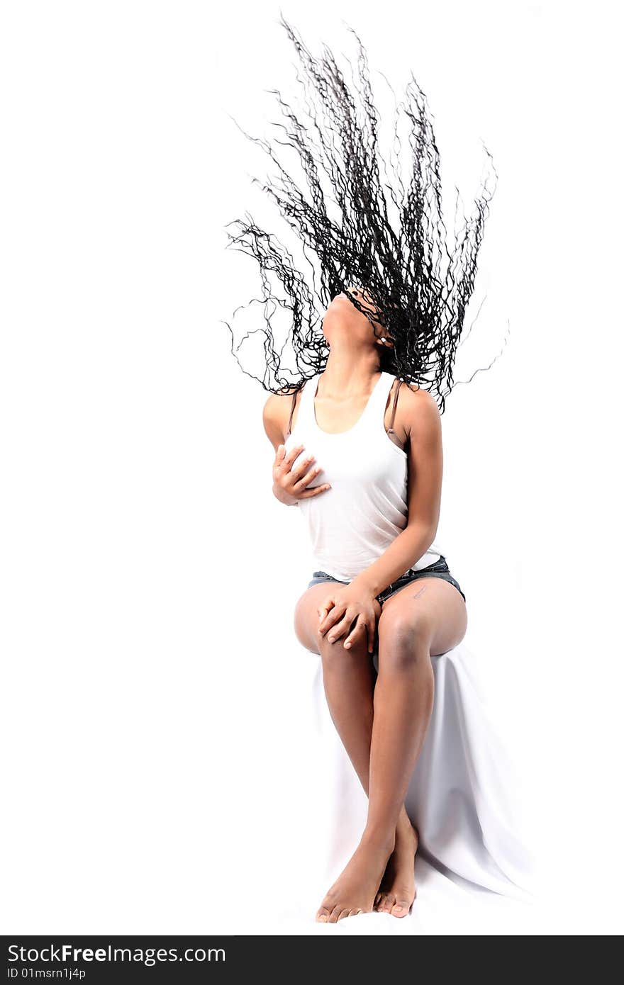 Wind - lovely young afro-american woman with long flapping hairs isolated on white