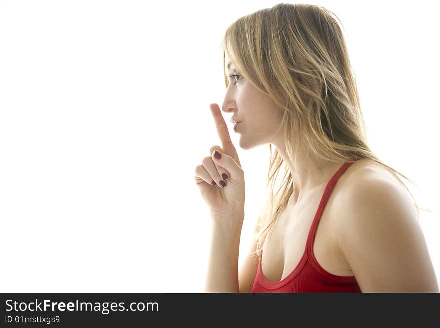 Young woman making silence gesture. Young woman making silence gesture