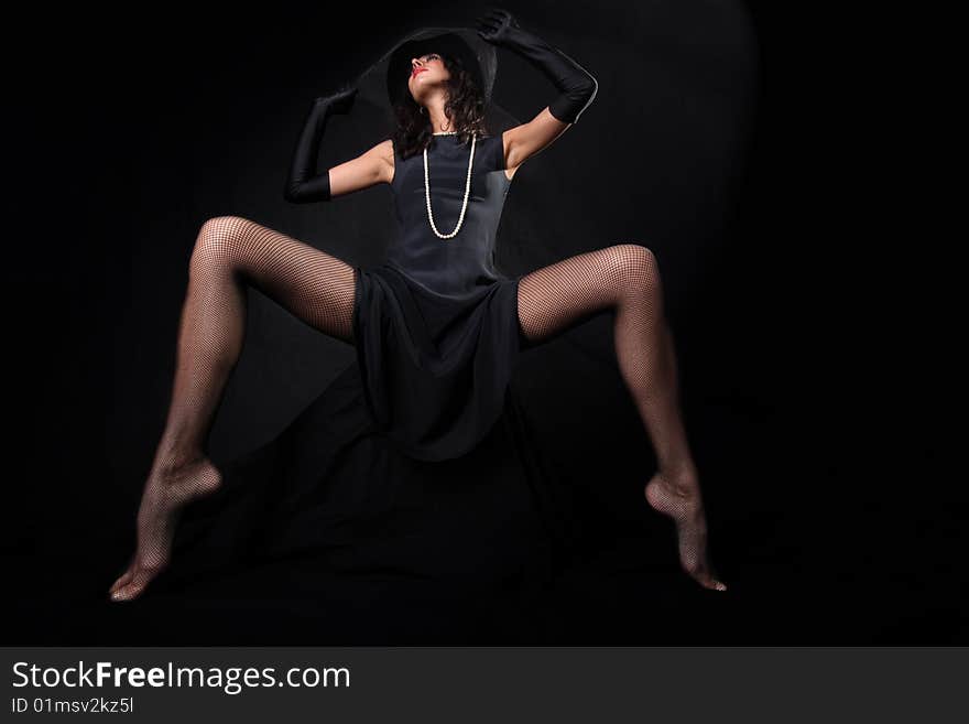 Girl with in hat with veil against black background. Girl with in hat with veil against black background