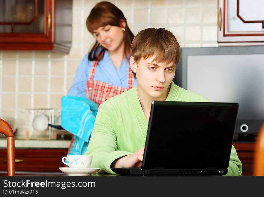 Happy young couple on a kitchen at home.