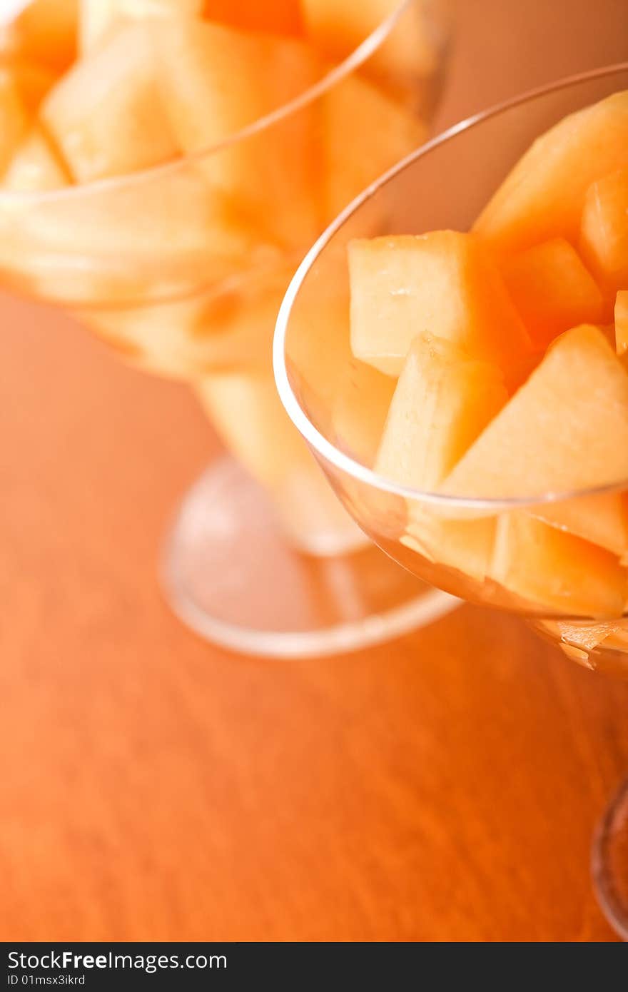 Cantaloupe cut and in parfait glass light background. Cantaloupe cut and in parfait glass light background