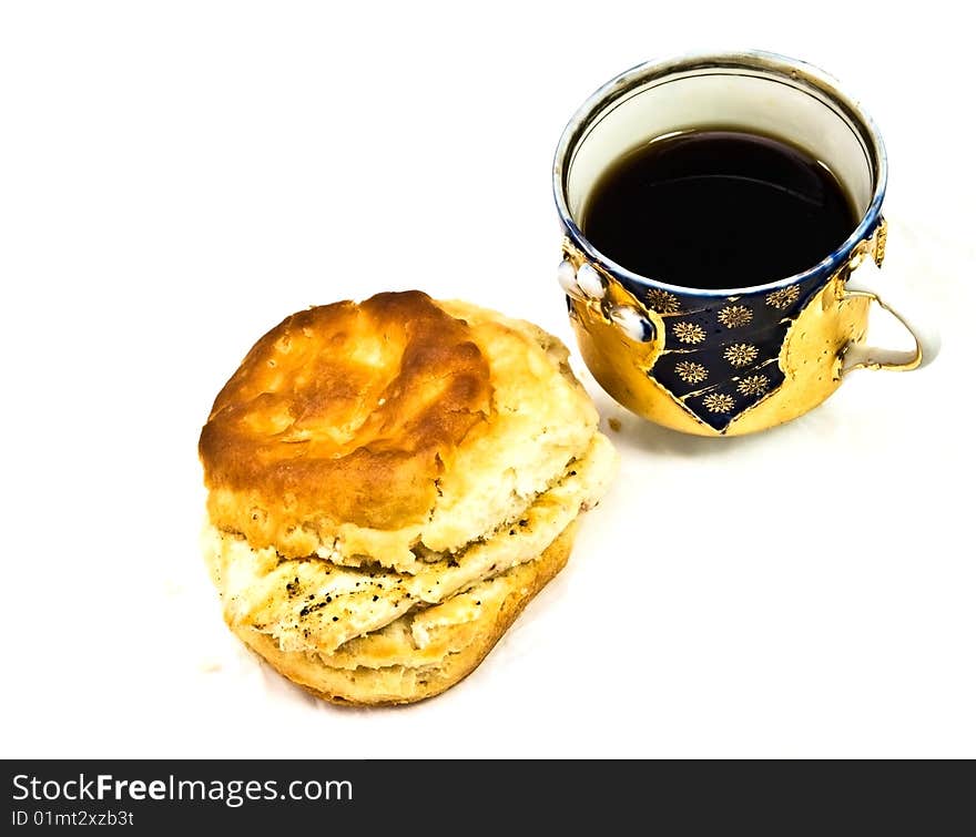 A decorative porcelain cup with coffee or tea and a grilled chicken biscuit for breakfast, snack or lunch. A decorative porcelain cup with coffee or tea and a grilled chicken biscuit for breakfast, snack or lunch.