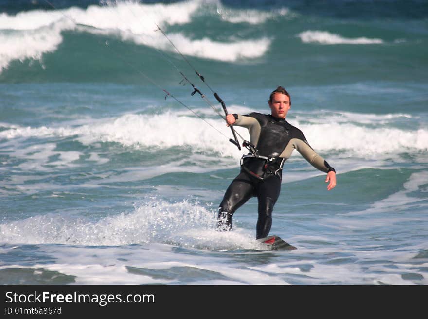 Kitesurfer surfing through the waves