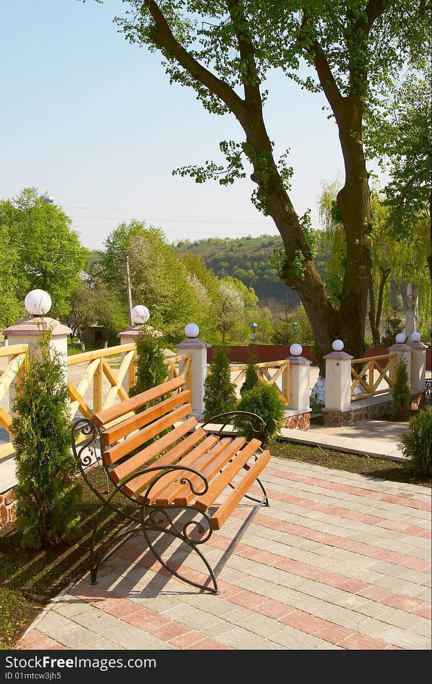 Wooden bench in the  modern spring yard.