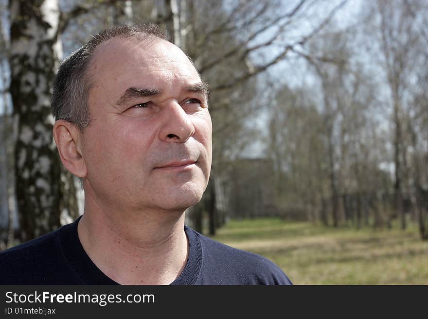 Portrait of mature man in a park. Portrait of mature man in a park