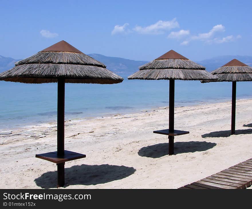 Parasols on a Greek beach. Parasols on a Greek beach