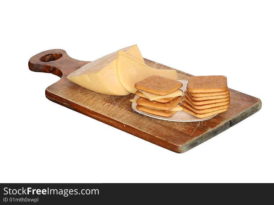 Crackers and cheese lying on breadboard isolated on white background. Crackers and cheese lying on breadboard isolated on white background