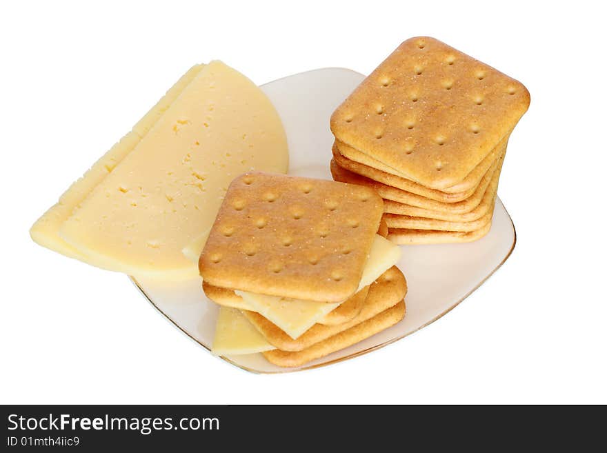 Stack of crackers and cheese lying on saucer isolated on white background with clipping path. Stack of crackers and cheese lying on saucer isolated on white background with clipping path