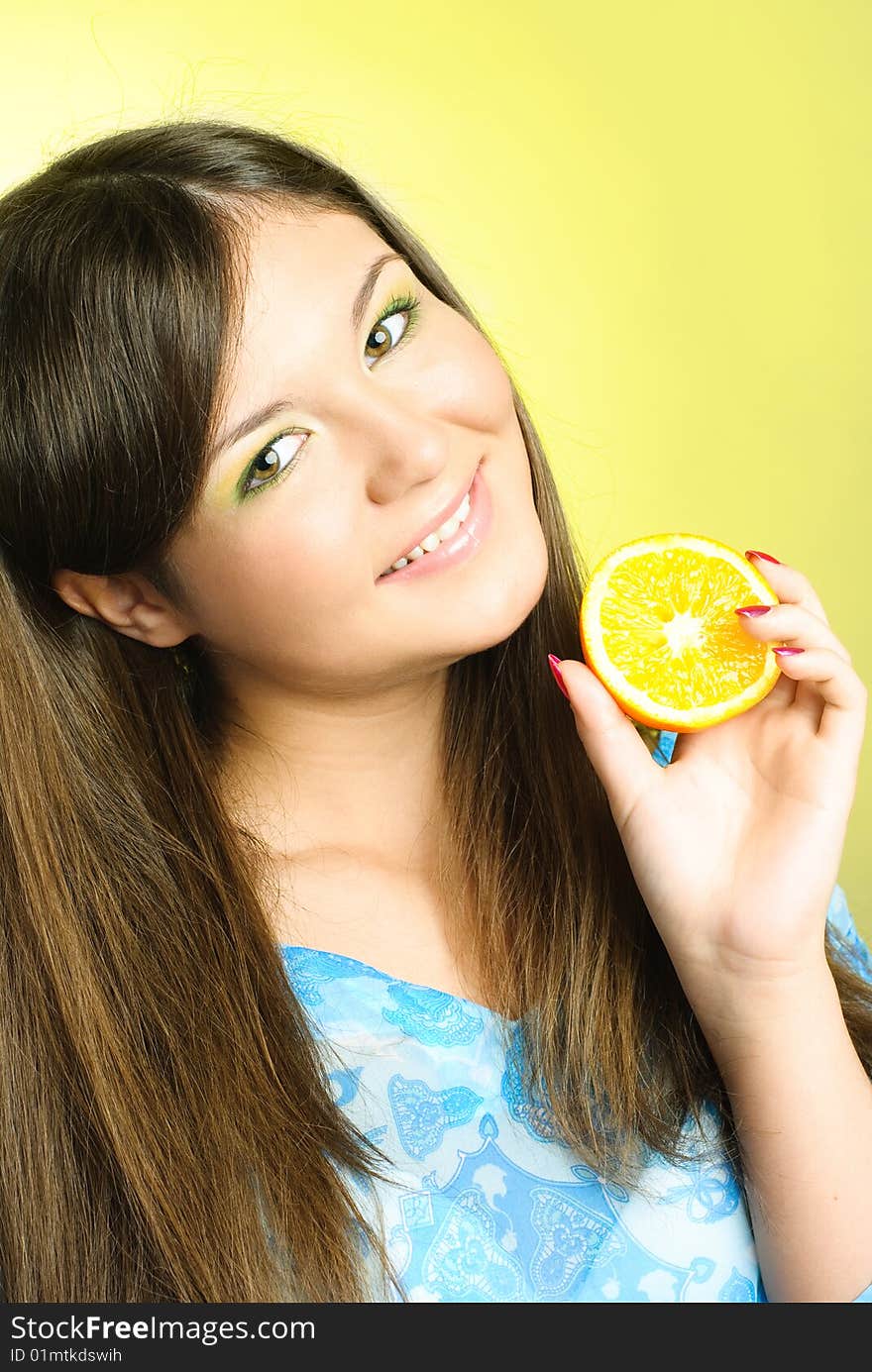 Portrait of pretty young brunette woman with an orange. Portrait of pretty young brunette woman with an orange