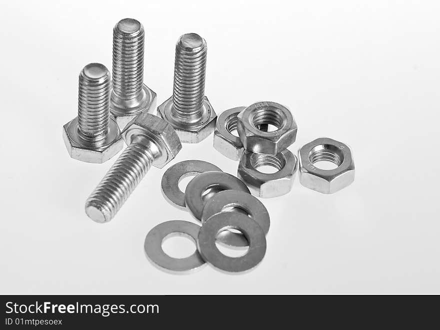 Bolts, screws and nuts on a white background. Bolts, screws and nuts on a white background