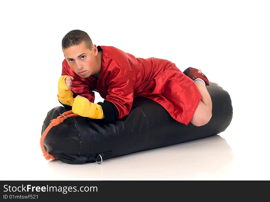 Youngster practicing the art of boxing with a punch-bag, studio shot on white background