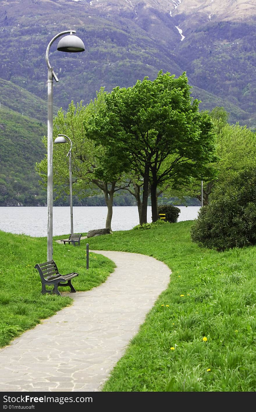 Driveway in the park with benches and lampposts. Driveway in the park with benches and lampposts