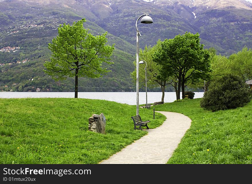 'driveway in the park with benches and lampposts