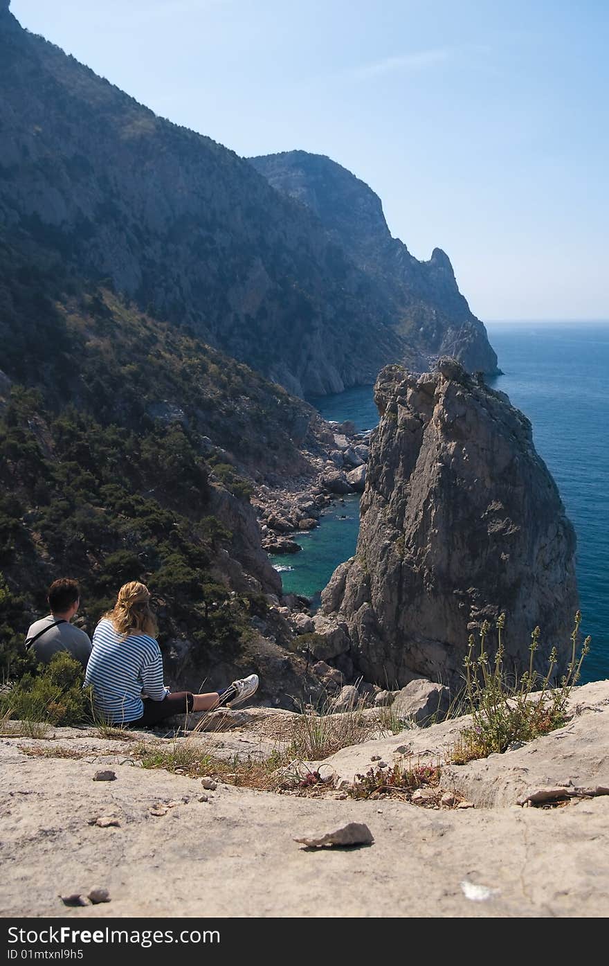 Unapproachable rock in the sea and tourists