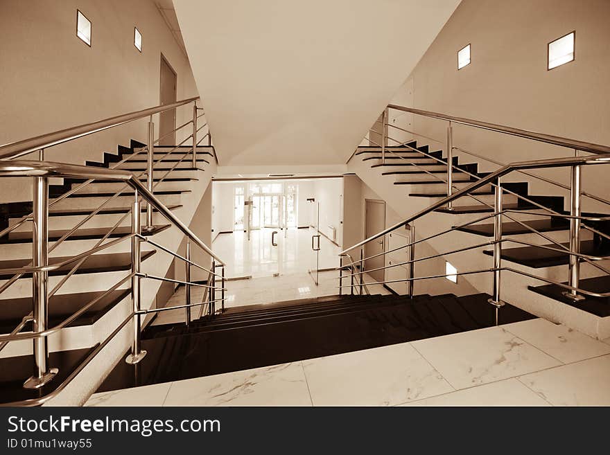 Glass doors with a kind on a marble staircase