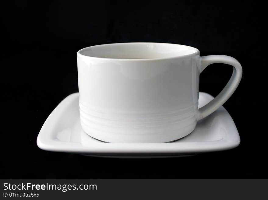 White coffe cup and plate on black background.