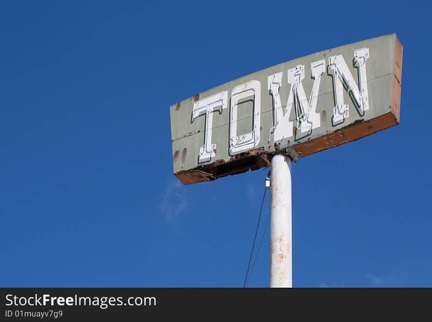 Vintage town sign with dark blue sky background. Vintage town sign with dark blue sky background.