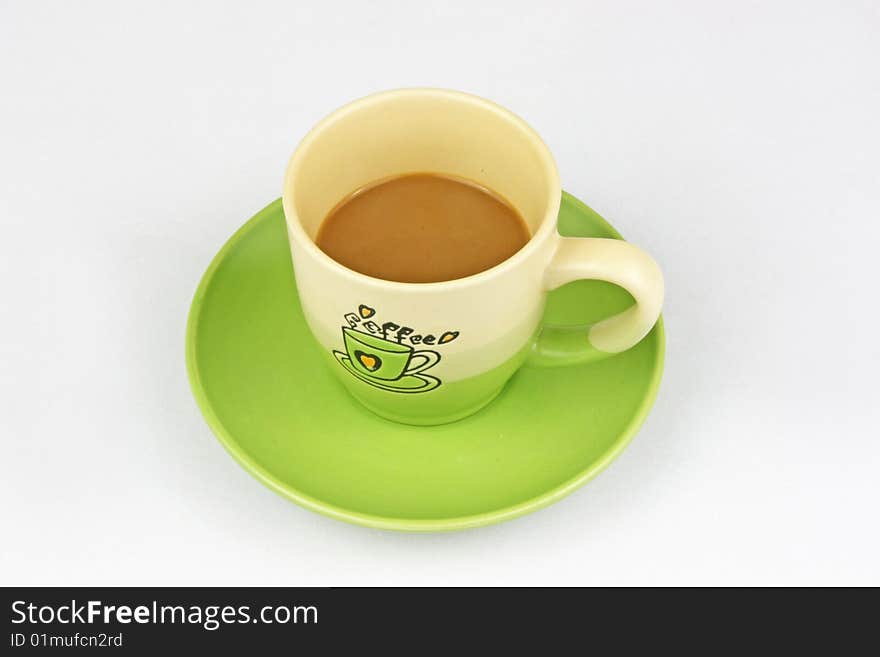 The green coffee cup is in white background