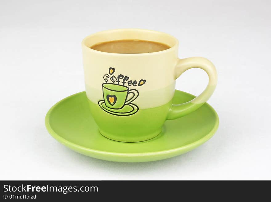 The green coffee cup is in white background