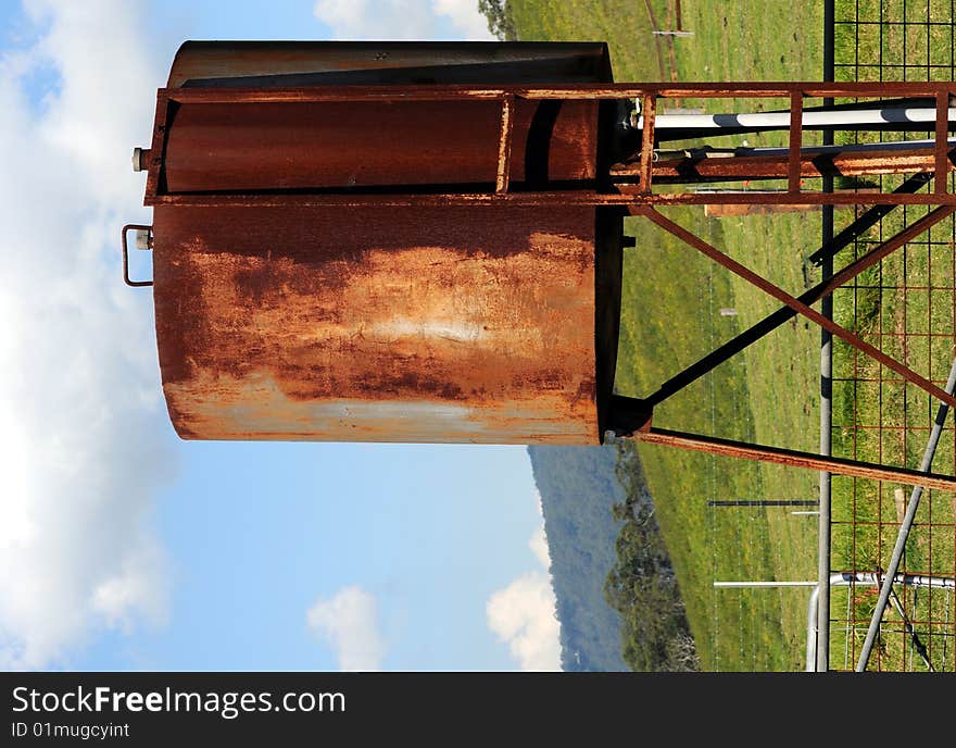 Rusted gas tank in landscape