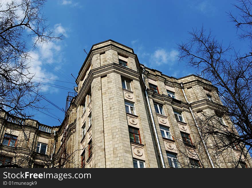 City fortress: multistory brick building on blue sky background