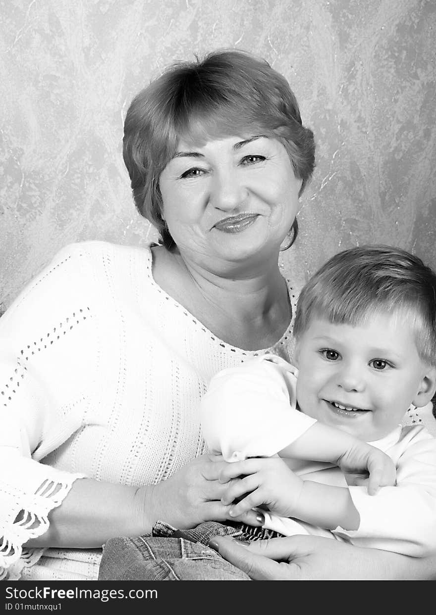 Portrait of the grandmother with the grandson in house conditions