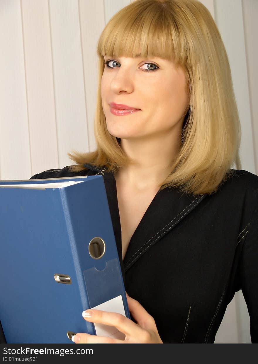 Folder for papers in hands at business of the woman in black clothes