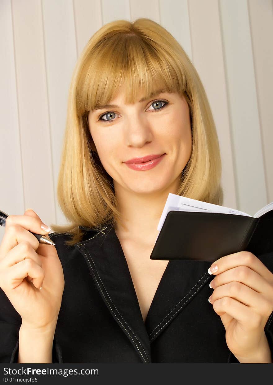 The beautiful businesswoman in a black jacket. The beautiful businesswoman in a black jacket