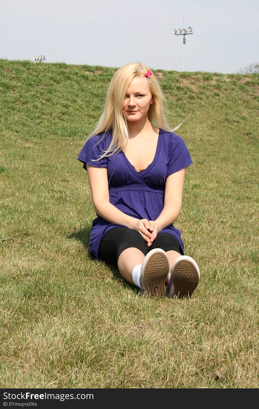 Girl sitting upon grass