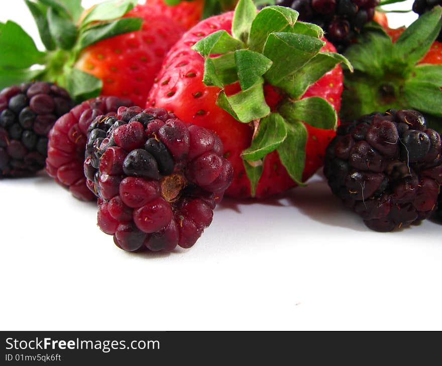 An arrangement of strawberries and blackberries on a white background. An arrangement of strawberries and blackberries on a white background