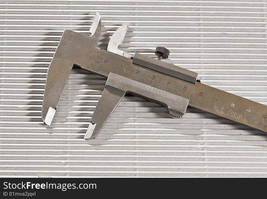 Tools series: metal trammel on ribbed surface