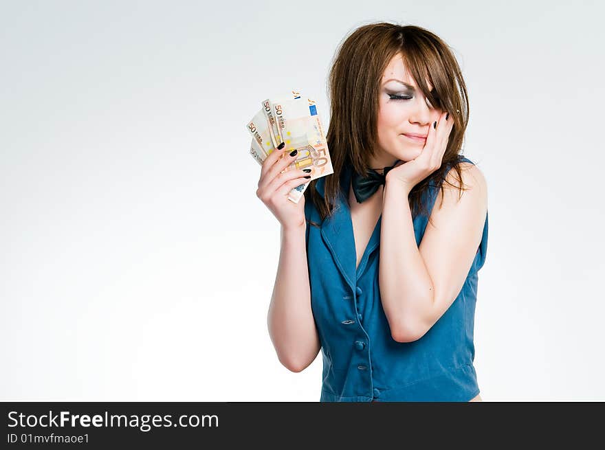 Girl in dealers outfit holding euro, studio shot