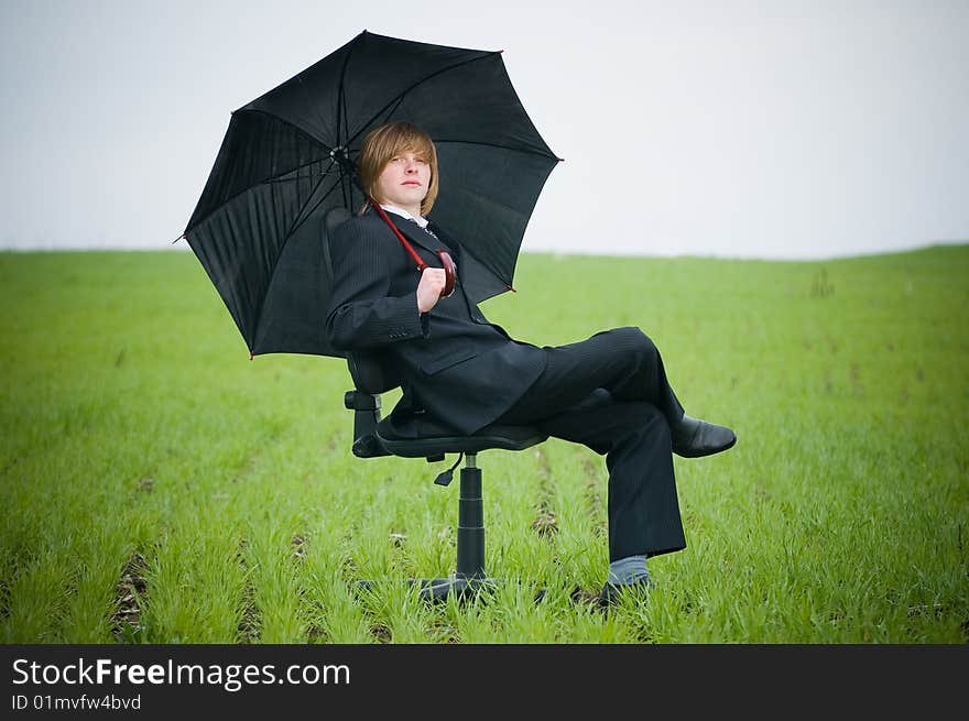 Handsome businessman with umbrella