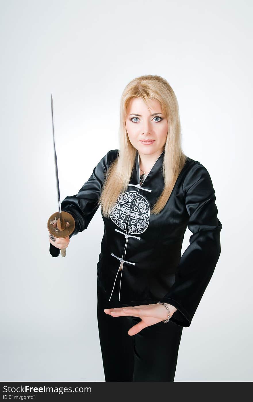 Beautiful woman with sword, studio shot